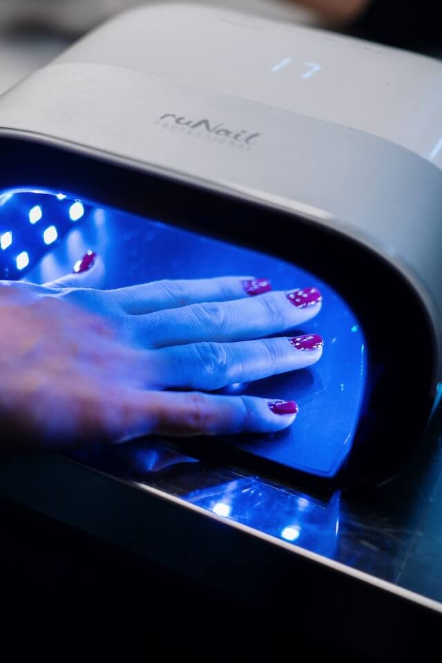 DND gel polish curing in UV lamp