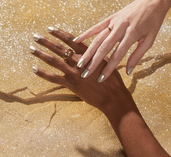 Two hands with gold nails