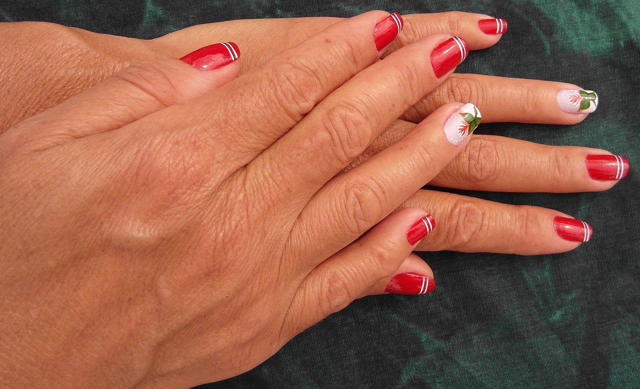 Hands With Red, Green and White Nail Art