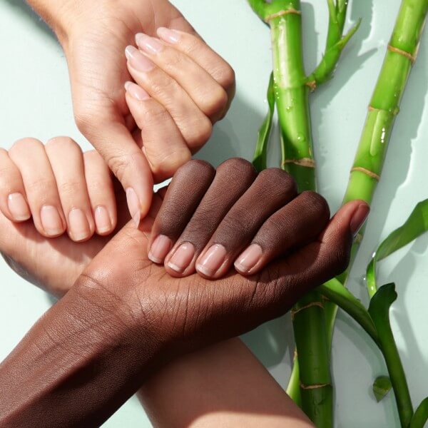 Three hands of different skin tones show healthy natural nails