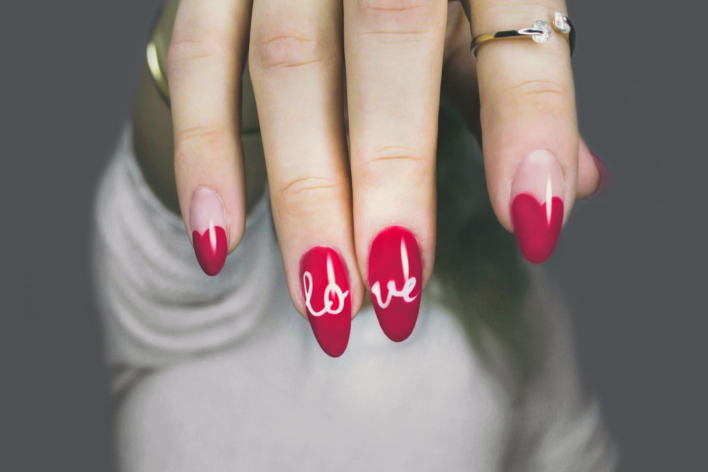 Close up of red nails with love written on them