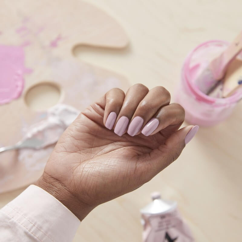 Hand showing pink colored acrylic nails