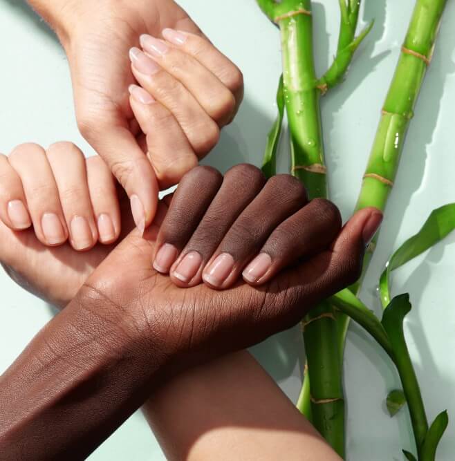 Three hands show natural nails with bamboo