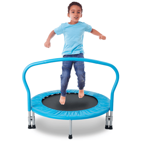 A young child on a blue indoor trampoline.