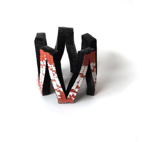 Bracelet red white and black shaped as all connected Vs 