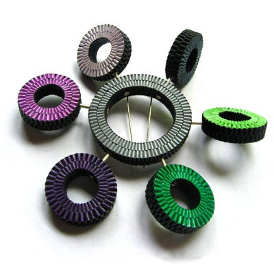 Brooch made of round handwoven elements that can independently rotate 