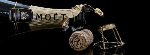 An open bottle of Moet & Chandon with a cork to the side.