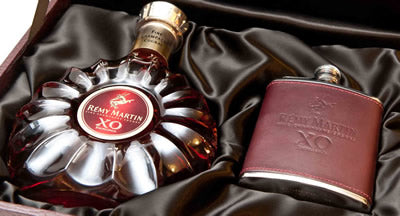 A bottle of Remy Martin cognac in a decorative case.