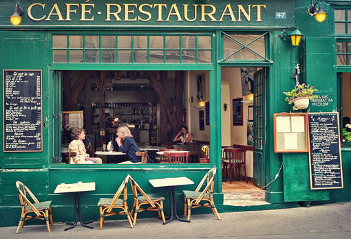 Two women enjoy tea at a cafe in Paris, France.