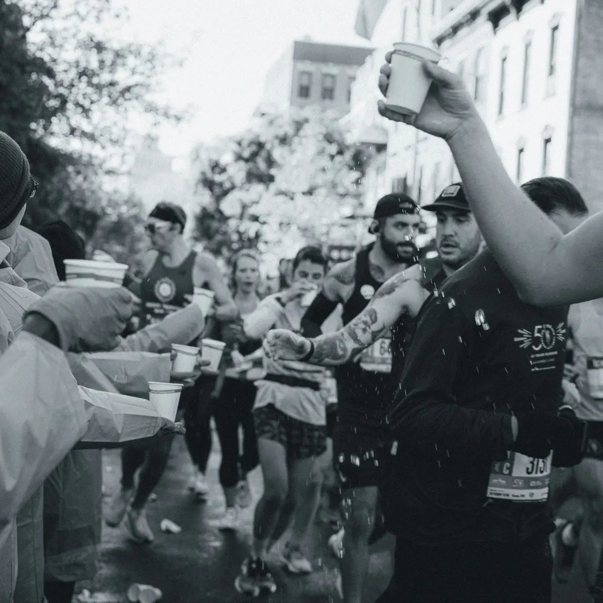 Volunteers offering marathon runners water during race