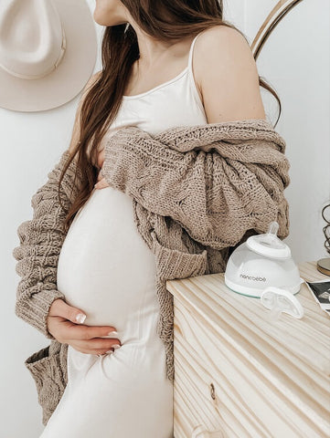 Pregnant woman holding belly.