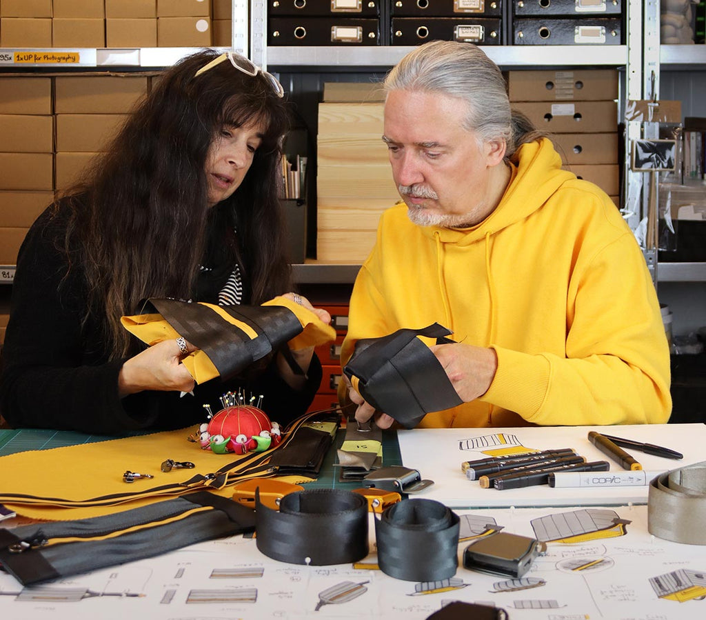 Marion Verbucken and Bertrand Rigot, co-founders of eKodoKi, designing together bags in their studio, sitting side by side