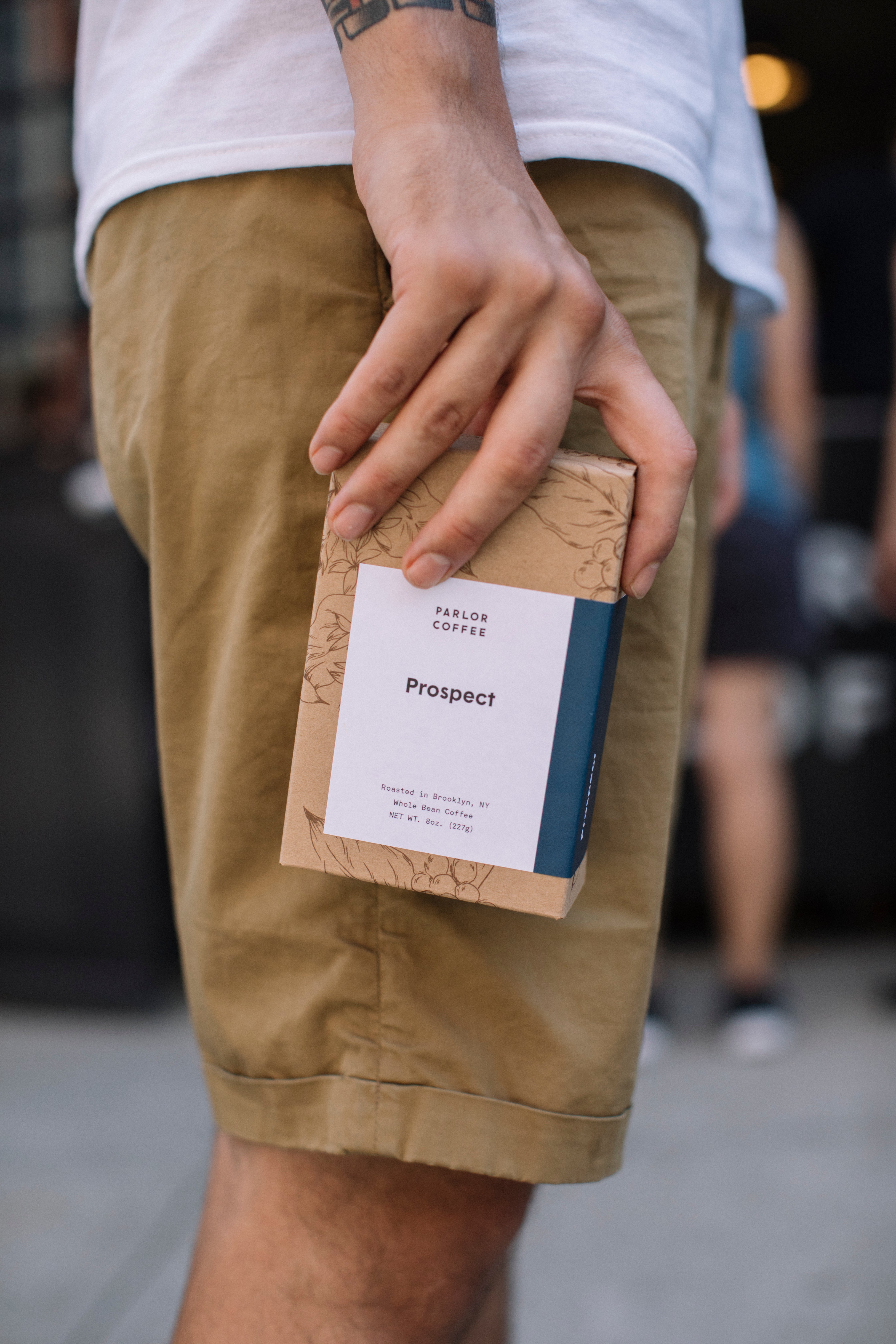 Person holding a box of Prospect Coffee