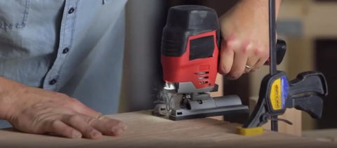 sawing notches into plywood for workbench