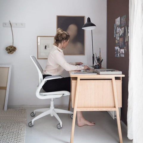 a woman working productively on her desk chair