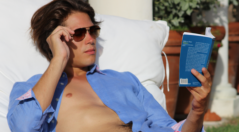 Holiday reading on Mustique, wearing Pink House linen shirt