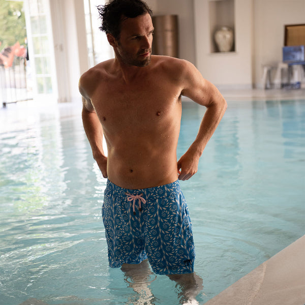 Man posing with swim shorts on