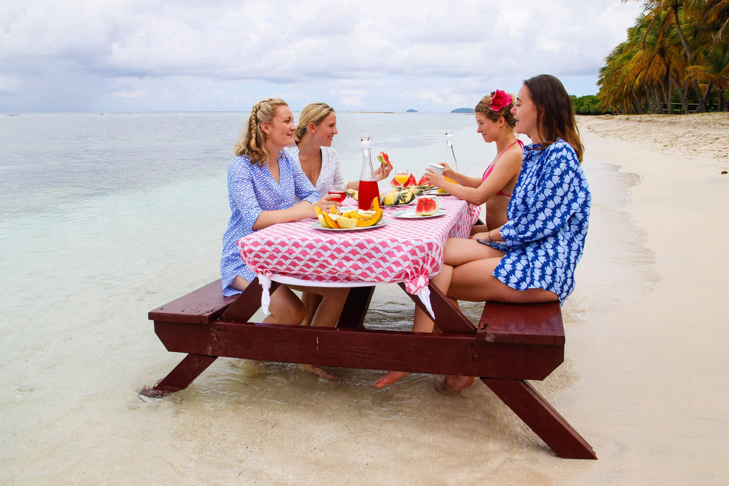 Sisters having a beach picnic, Mustique