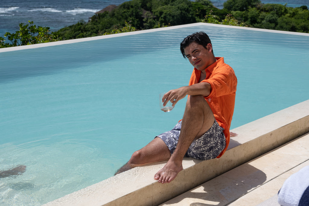 Aubergine Protea print swim shorts teamed with orange linen shirt