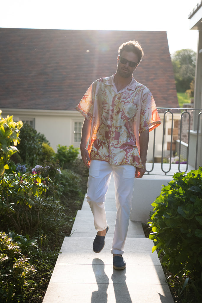 Silk scarf shirt as evening wear with white linen trousers