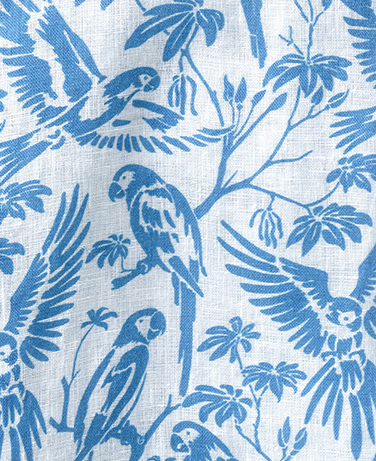 section of parrot print in blue on white linen