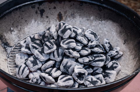 Extinguished Charcoal at the Bottom of a Charcoal Grill