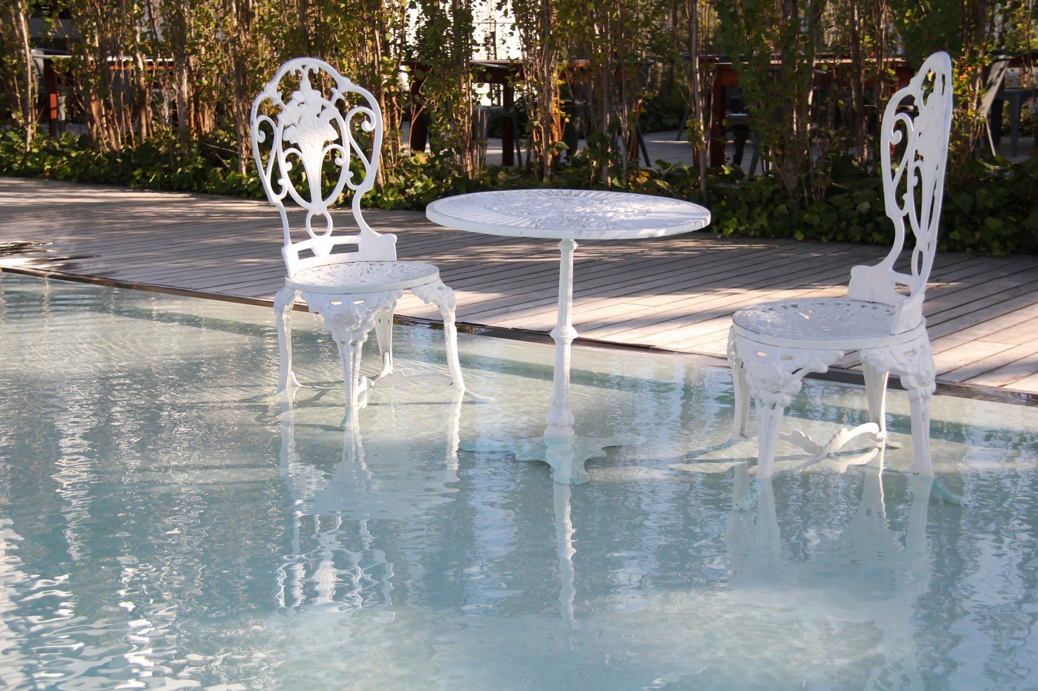 Garden Furniture on the shallow area of the pool design. By MEM Interiors