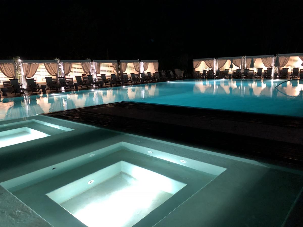 A night view of the custom pool design. By MEM Interiors