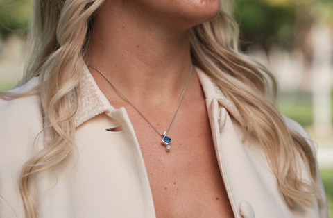 woman wearing 5 year anniversary sapphire pendant