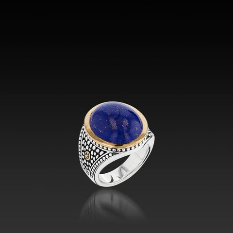 A close-up of a colored gemstone ring showcasing a men's jewelry trend