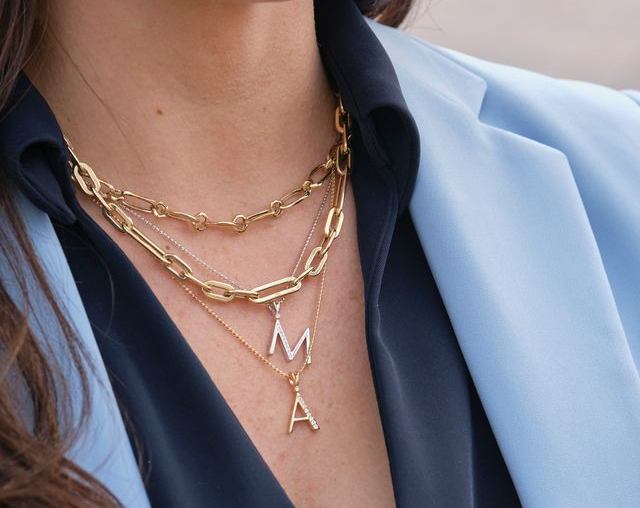 woman wearing letter initial necklaces layered