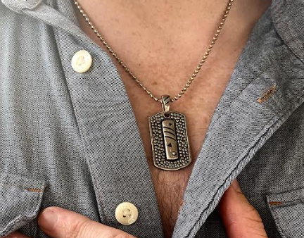 photo of a man wearing the latest men's jewelry pendant necklace design by John Atencio