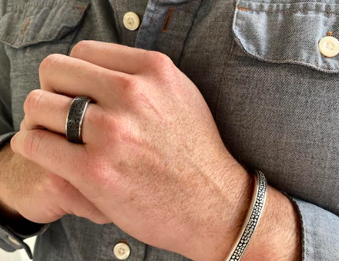 closeup photo of a man wearing the latest men's bracelet and ring jewelry trends by John Atencio