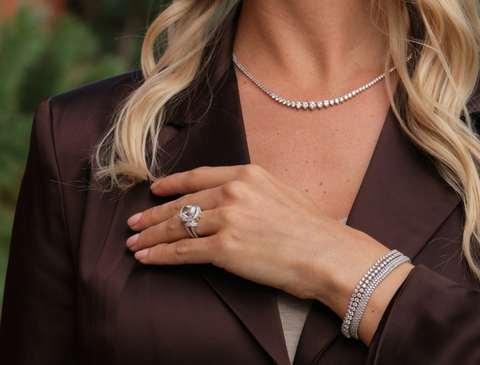 woman wearing a natural diamond tennis necklace and engagement ring