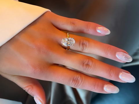 woman wearing an oval cut engagement ring