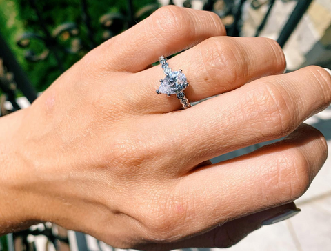 woman wearing an pear cut engagement ring