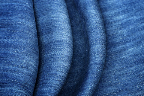 A close-up of blue stretch denim fabric