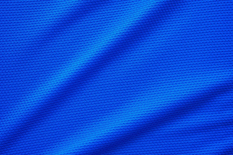 A closeup shot of a blue-coloured polyester fabric.