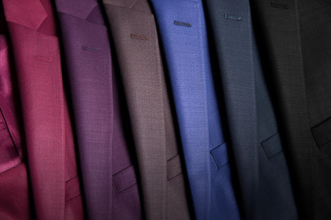 Plain multi-coloured blazers aligned next to each other.