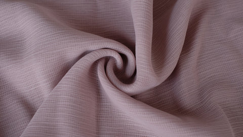 A closeup shot of soft brown-coloured viscose fabric.