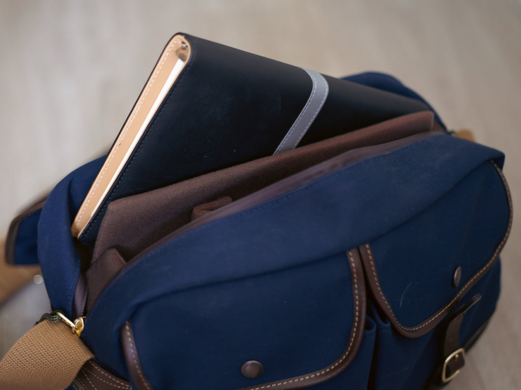 Billingham Mini Eventer Camera & Tablet bag with book in the tablet compartment.