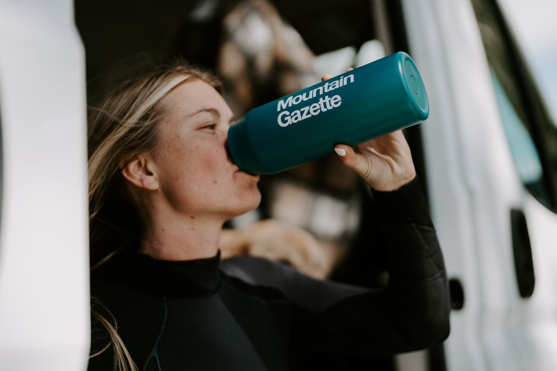 Female Surfer Drinking from Mountain Gazette X MiiR Wide Mouth Water Bottle