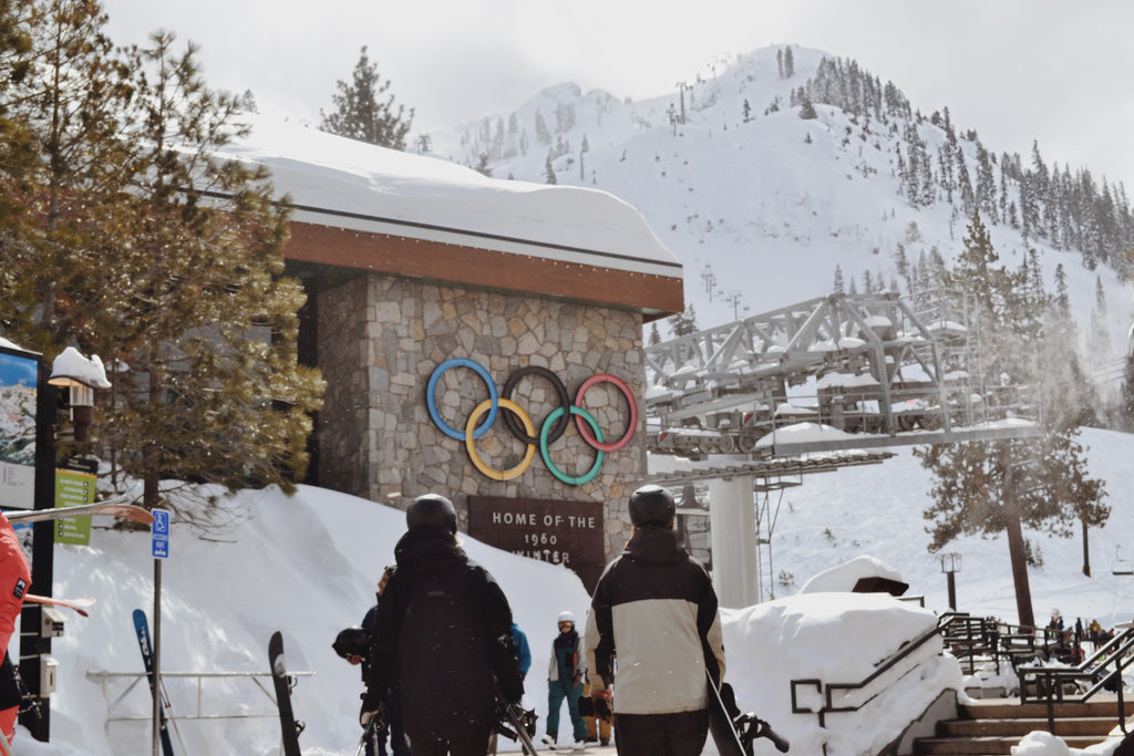 Snowboarders walking into Palisades