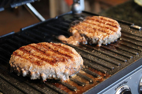 Two burger patties on the grill