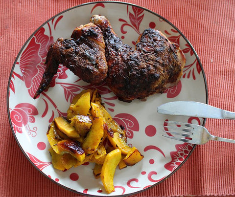 A plate with chicken and pumpkin vegetable