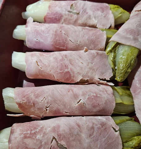 Endive, rolled into ham and placed in a gratin dish