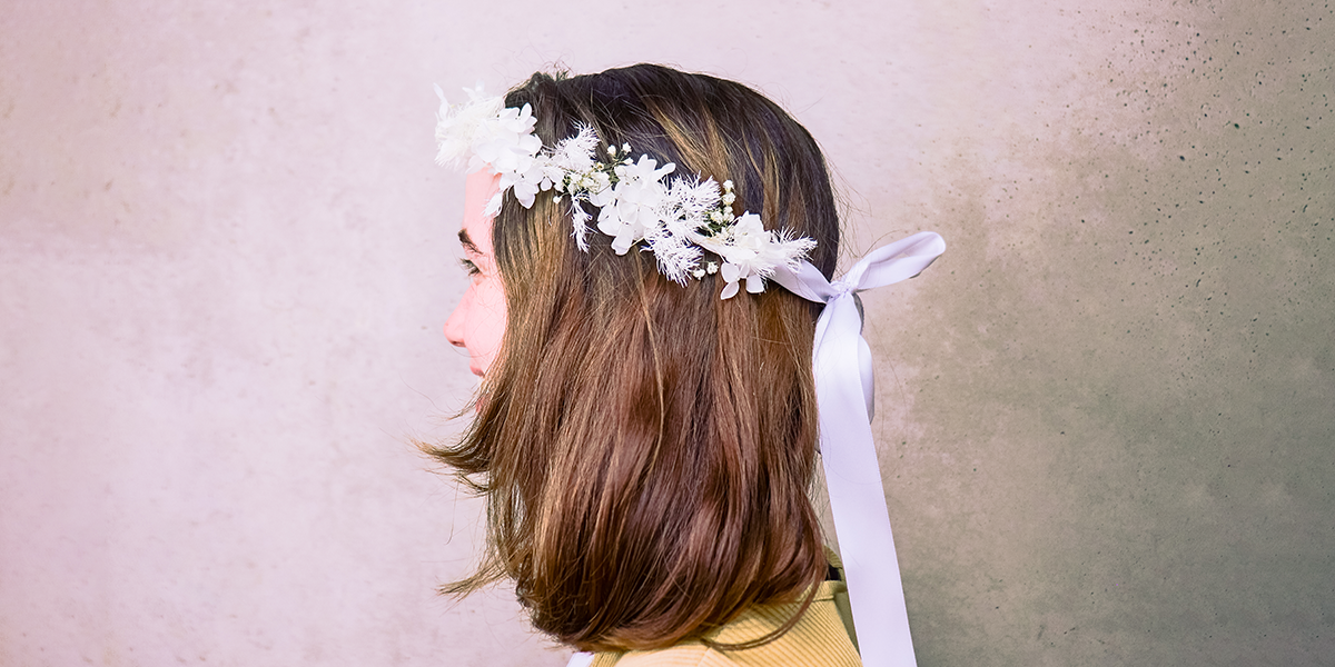 Woman wearing a flower crown on her head and smiling