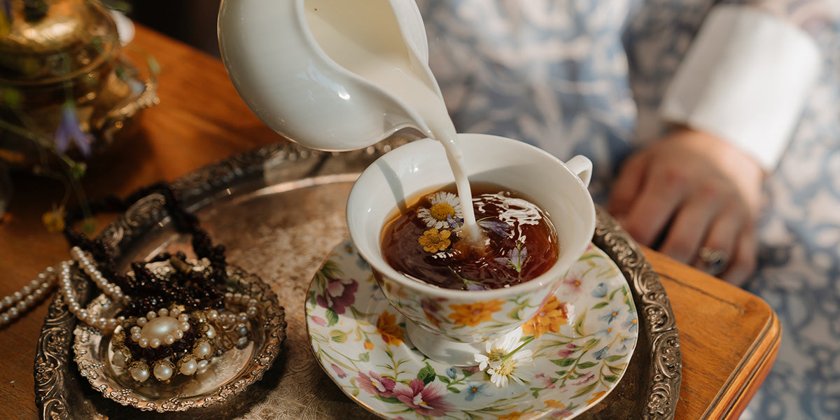 Dried edible flowers on top of tea in a cup