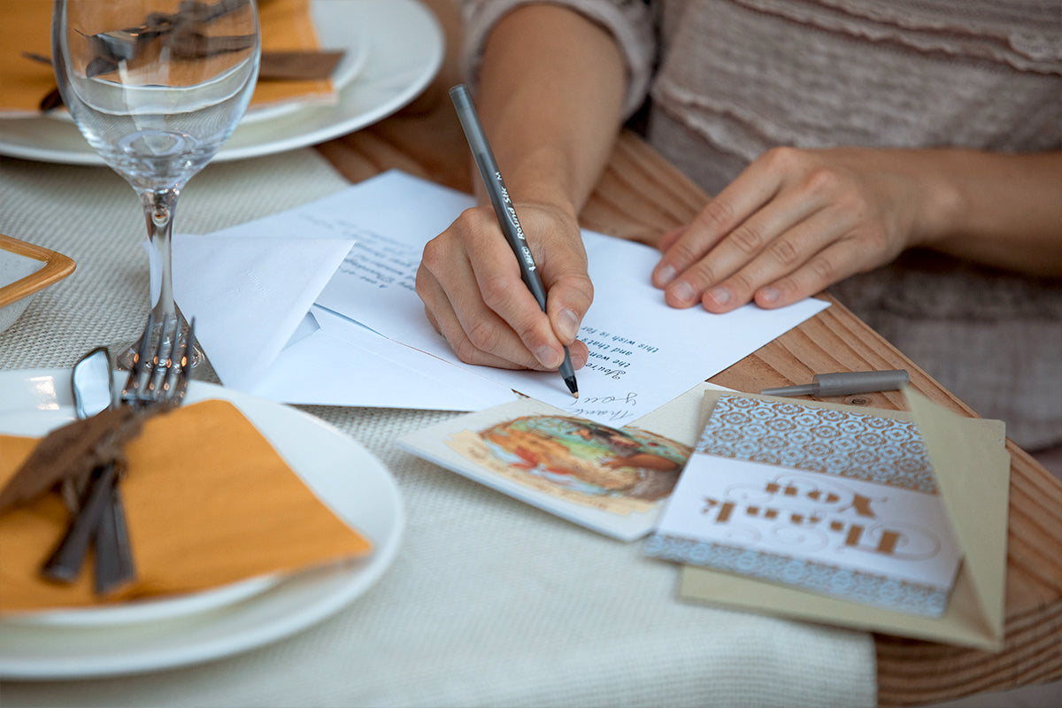 person writing on a card