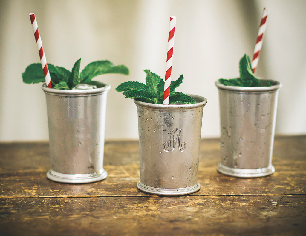 three mint julep cups with straws